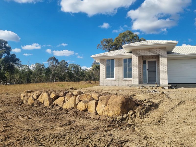 Finished house pad with rock retaining wall on a lifestyle block