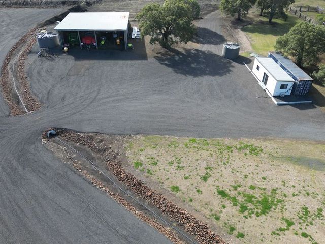 Lifestyle block earthworks — shed pad, driveway and rock-lined drainage