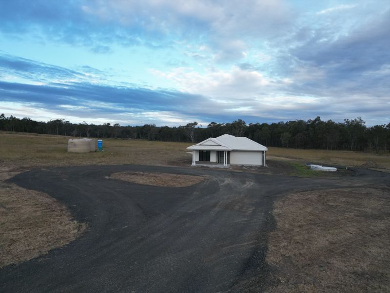 Newly formed driveway loop around a finished house on a rural lifestyle block