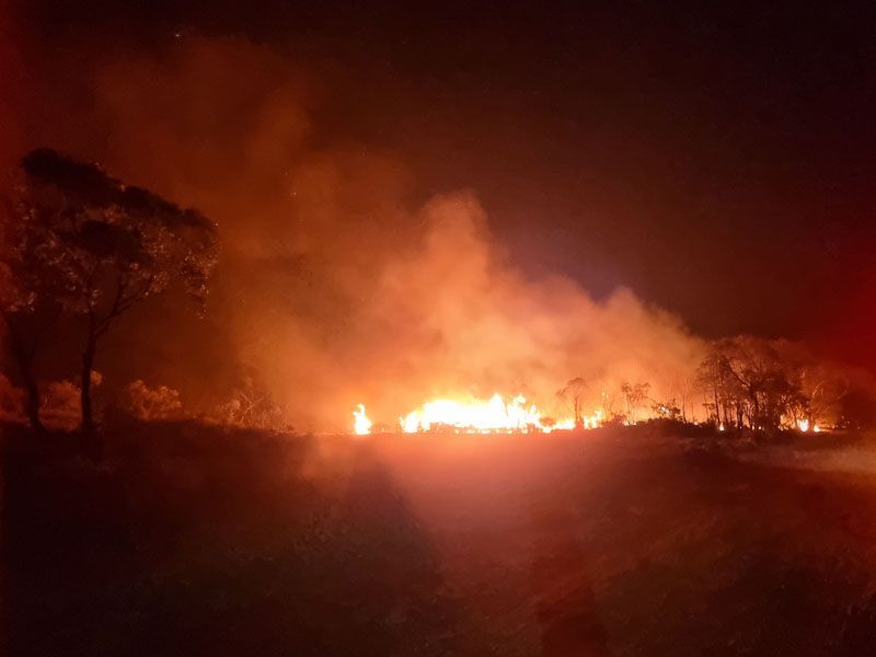 Controlled burn at night along a maintained rural firebreak